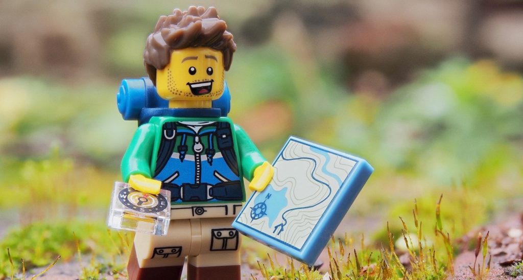 A Leggo hiker with a giant map